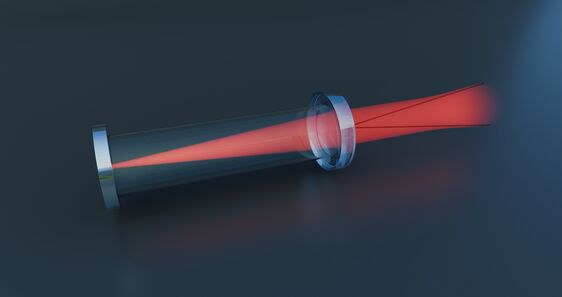 Depiction of a focused red laser beam passing through a glass tube. The laser beam narrows in the center of the tube before spreading out again. The scene emphasizes the precision and focusing of the light beam in optical applications.